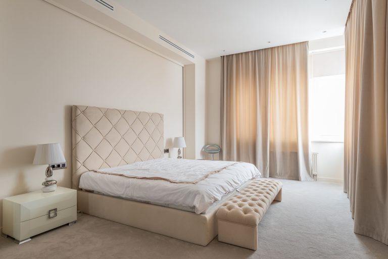 Cream wall-to-wall carpet in a bright Alabama bedroom