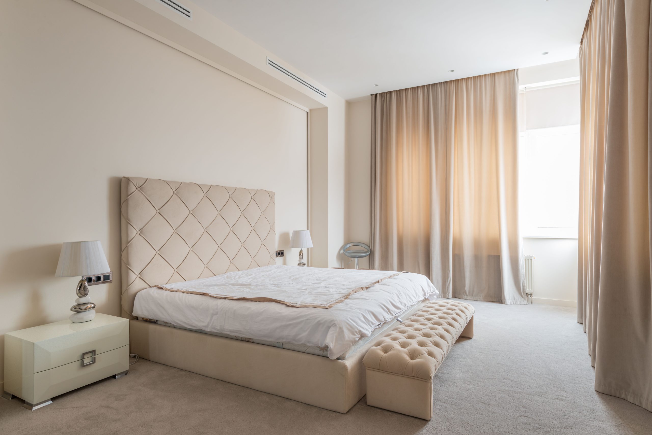 Cream wall-to-wall carpet in a bright Alabama bedroom