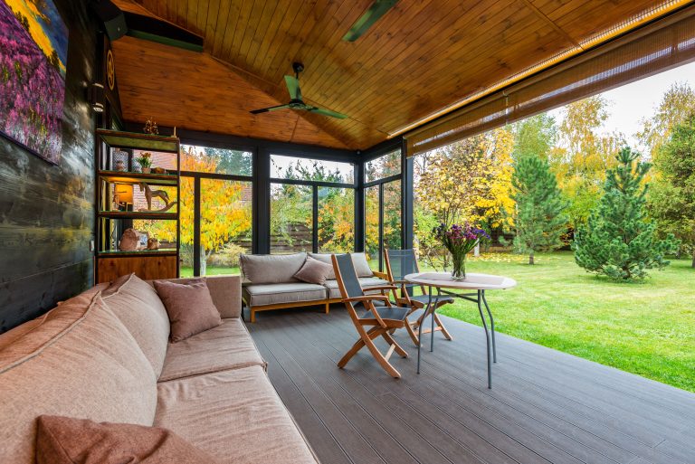 A covered Alabama porch with a timber ceiling and a hard-wearing deck floor opening onto the yard