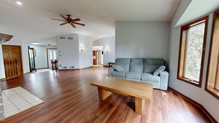 Bright, modern living room featuring hardwood floors and neutral decor